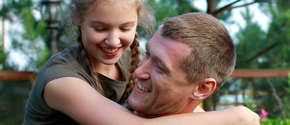 Smiling white girl being physically supported by white man